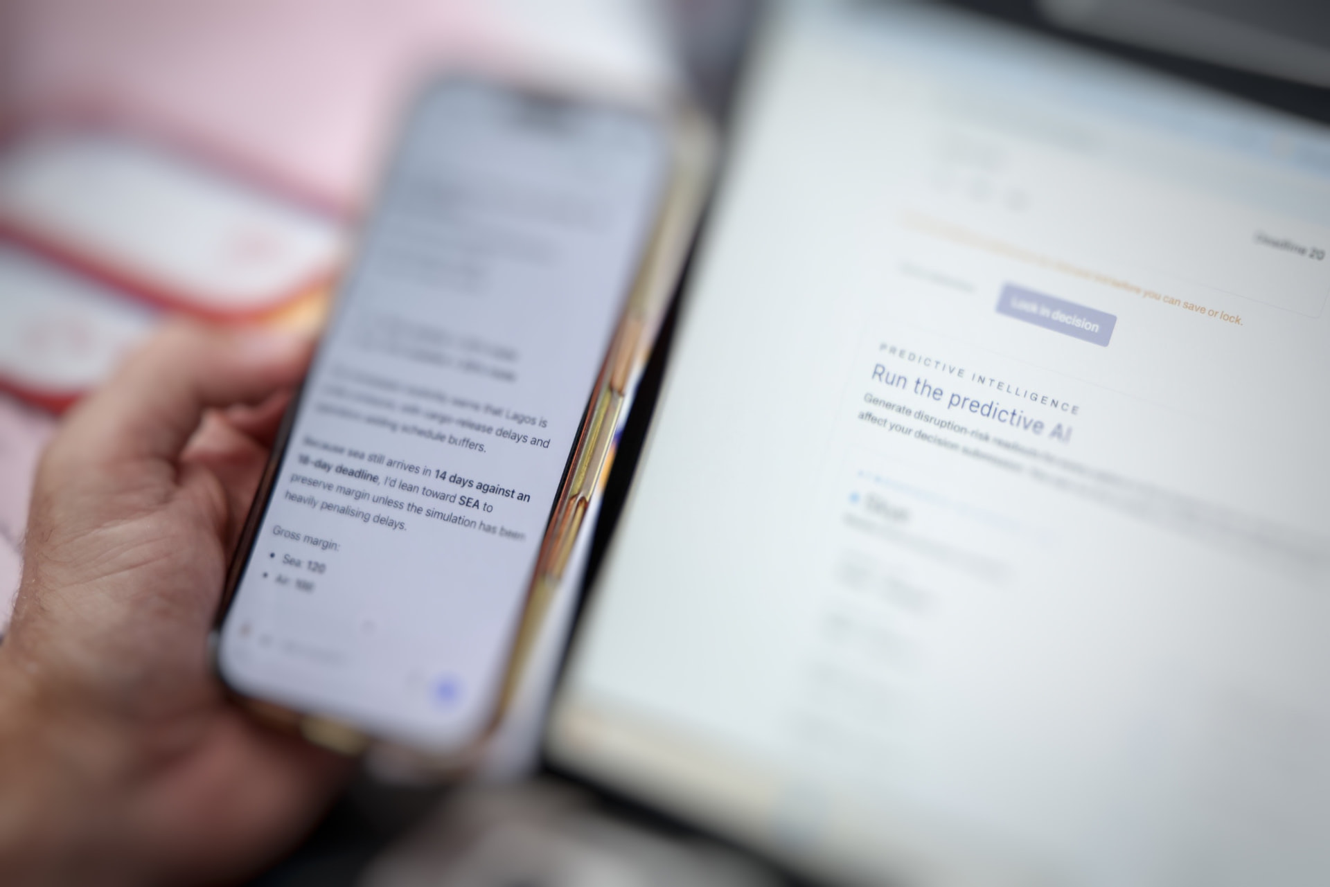 A phone showing an AI-assisted reasoning session next to a laptop